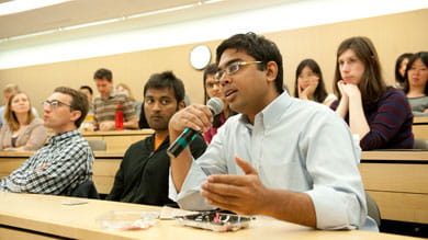 Students pose questions during the May 31 debate over whether social media will advance democracy in the Middle East