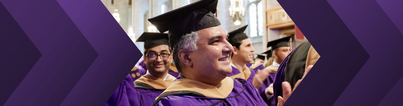 Kellogg Executive MBA graduates in cap and gown, gathered in the chapel for graduation