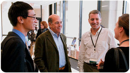 Andrew Youn '06, Larry Levy '67 and John Wood '89 interact with Sandra Anderson '07 at the 2006 Net Impact Conference