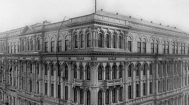Black and white photo of a campus building with columns