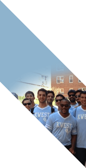 A group of Kellogg students wear matching shirts and smile.