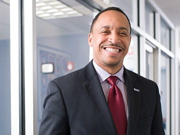 A portrait of Alan Anderson, class of '04, who fights gun violence through job training and placement.