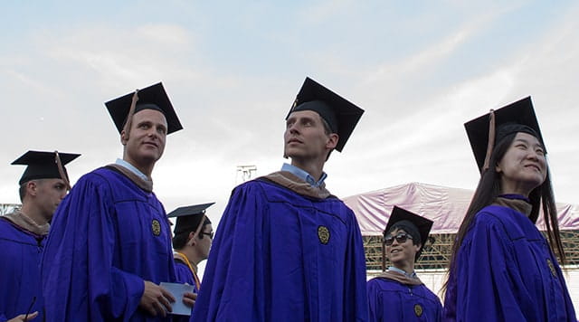 Kellogg graduates line up to receive their diplomas on graduation day.