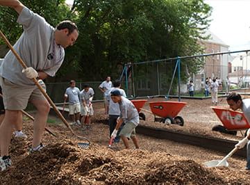 Volunteers help in landscaping a local park.