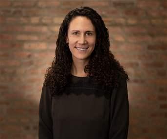 Alumni of Program standing with brick background