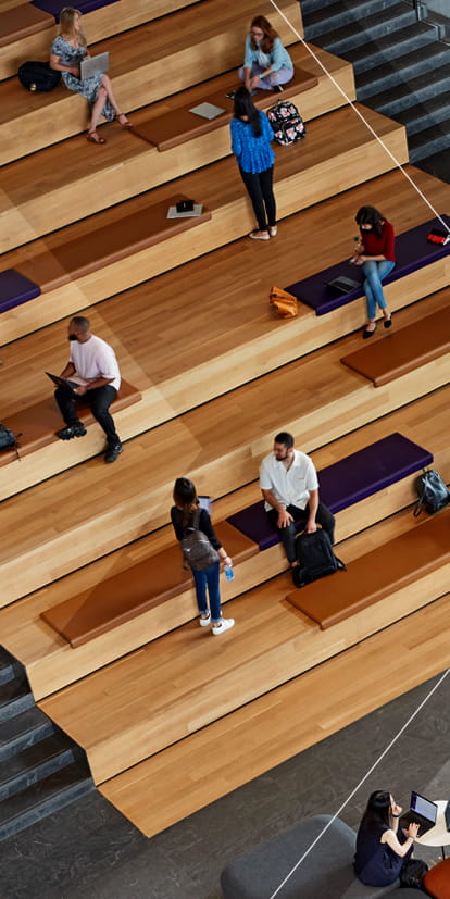 Students chatting and collaborating in an open area of the Global Hub.