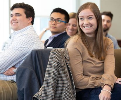 Multiple Kellogg students smiling while attending an event