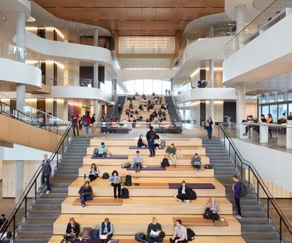 Students sitting on the Spanish steps inside the Global Hub