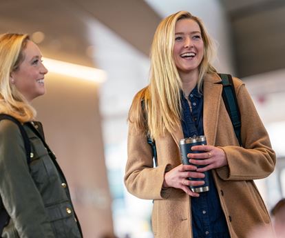 Two students smiling and talking