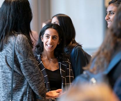 Students talking to each other at an event at Kellogg