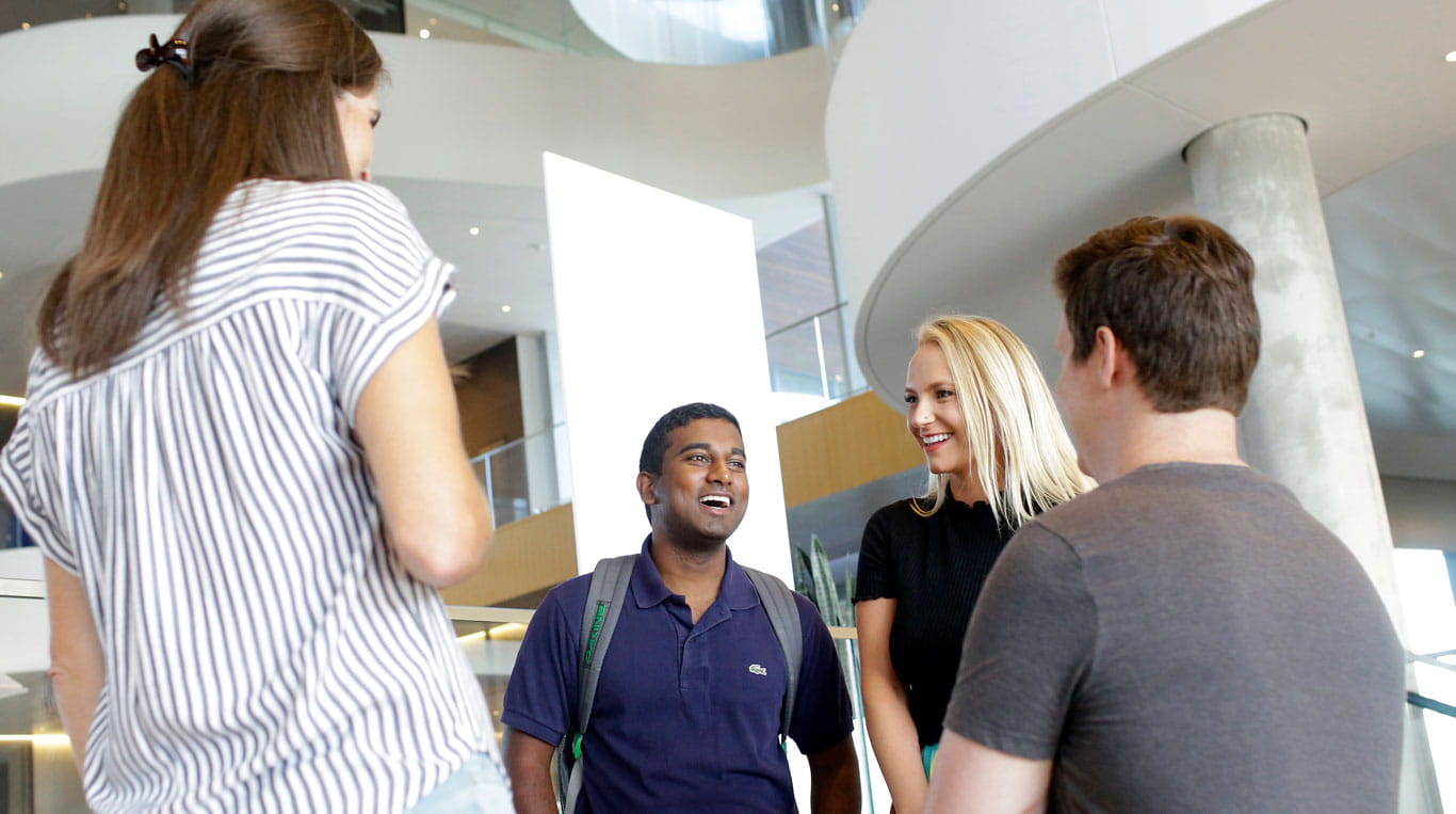 Students talking in Kellogg's Global Hub