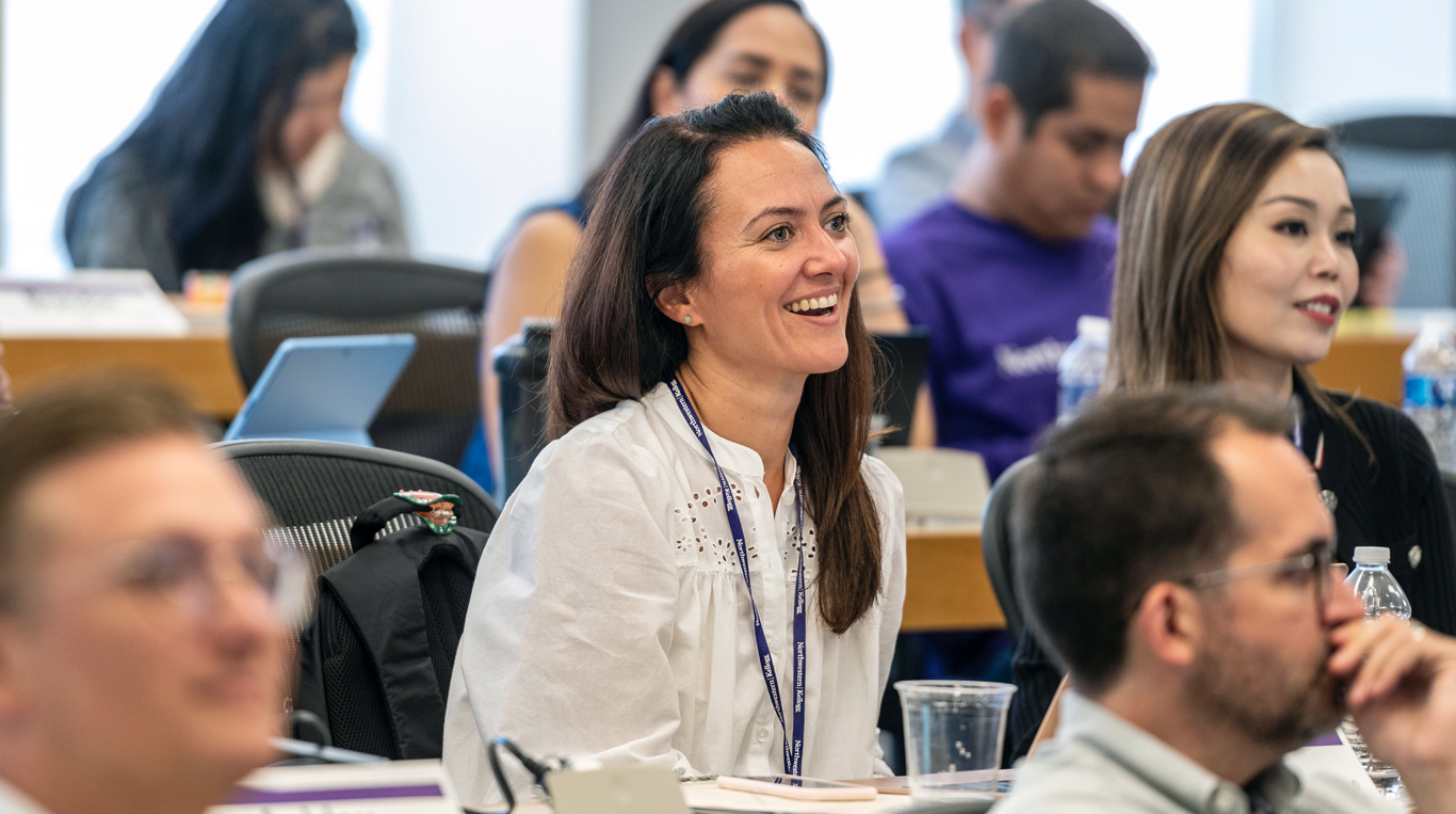 Woman smiling during class at the EMBA program at Kellogg