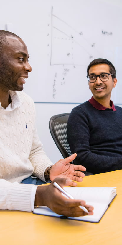 Students smiling in a study hall together.