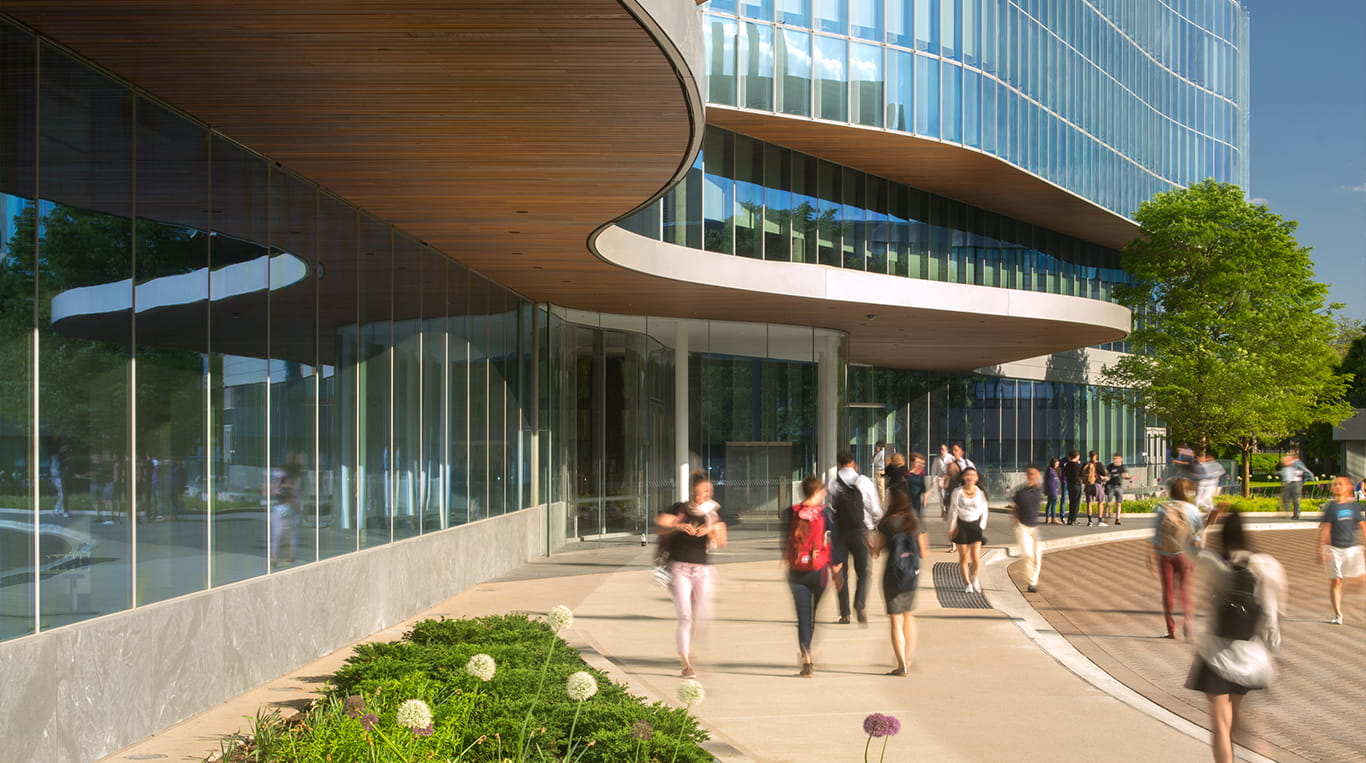Kellogg students walking on campus on a sunny day.