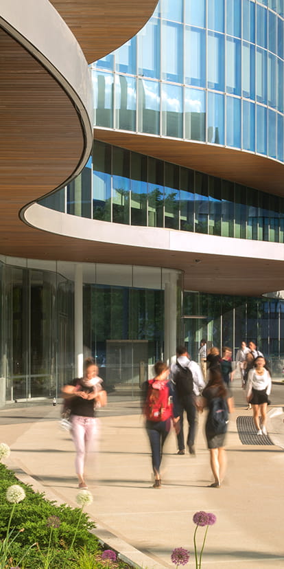 Kellogg students walking on campus on a sunny day.