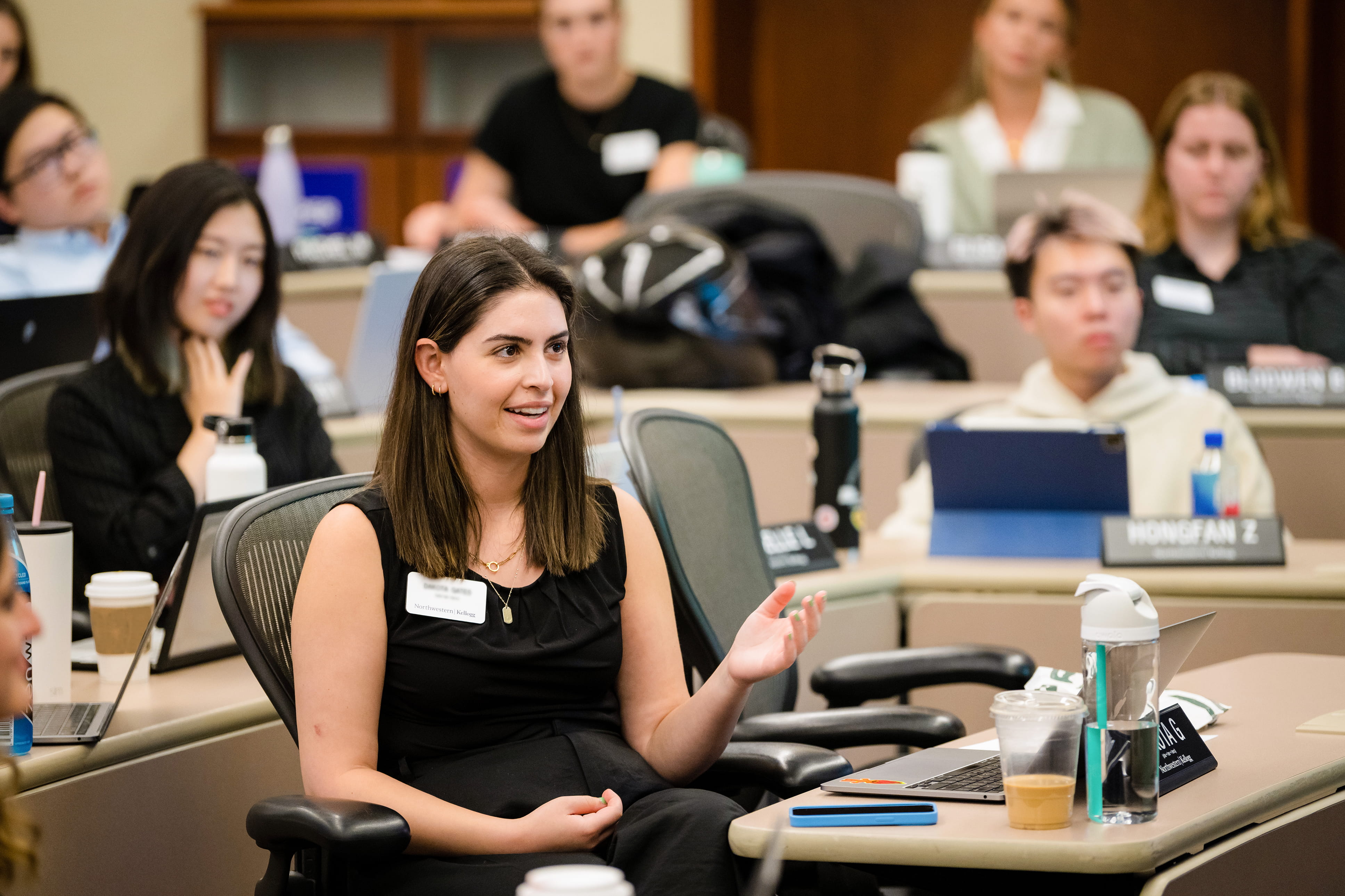 Woman talking in class as part of the Kellogg MiM program.