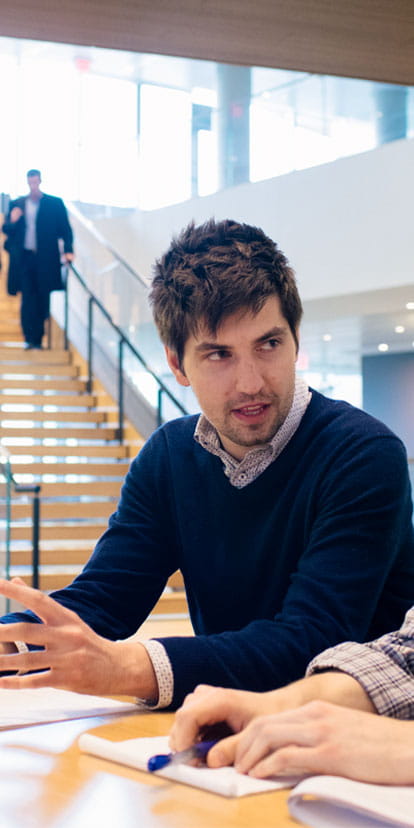 PhD students at Kellogg having a discussion at the Global Hub.