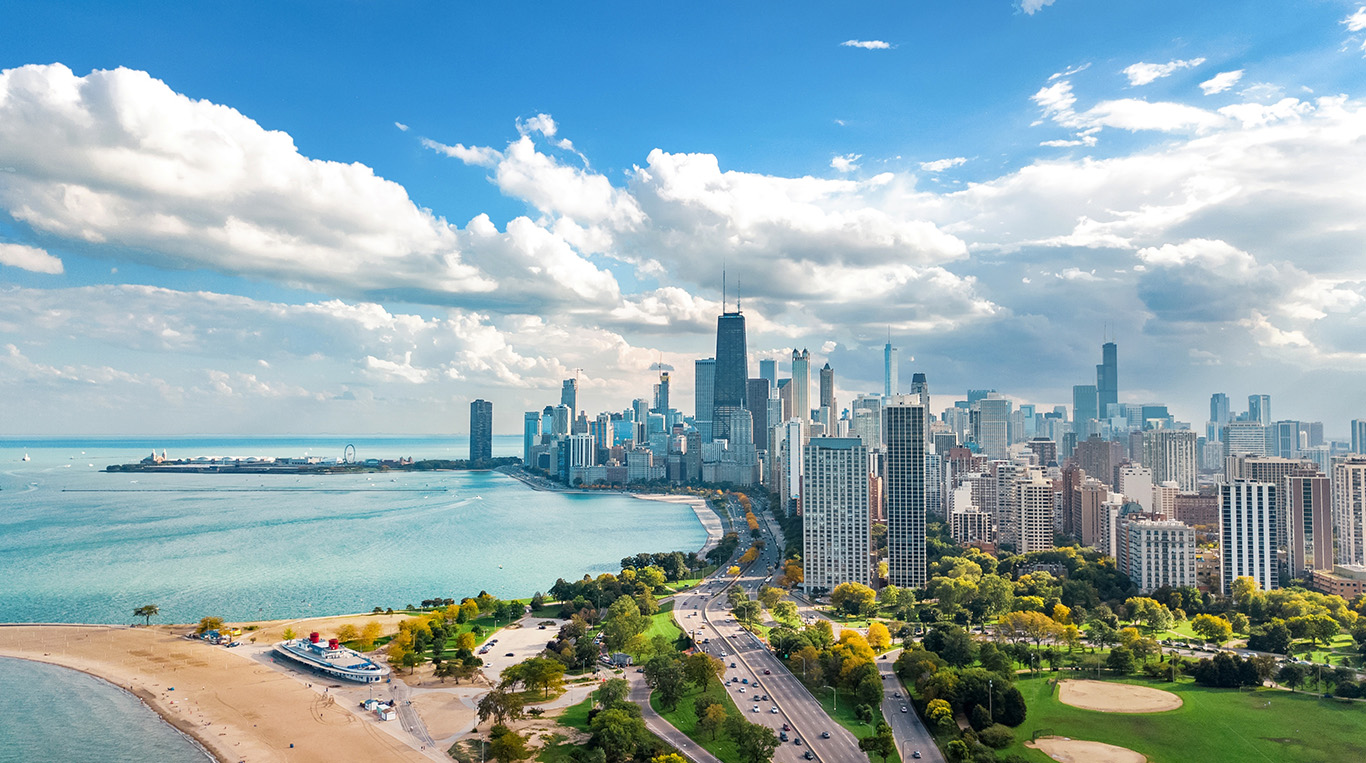 Sunny, blue sky day with view of downtown Chicago high rises, beaches, and lakefront