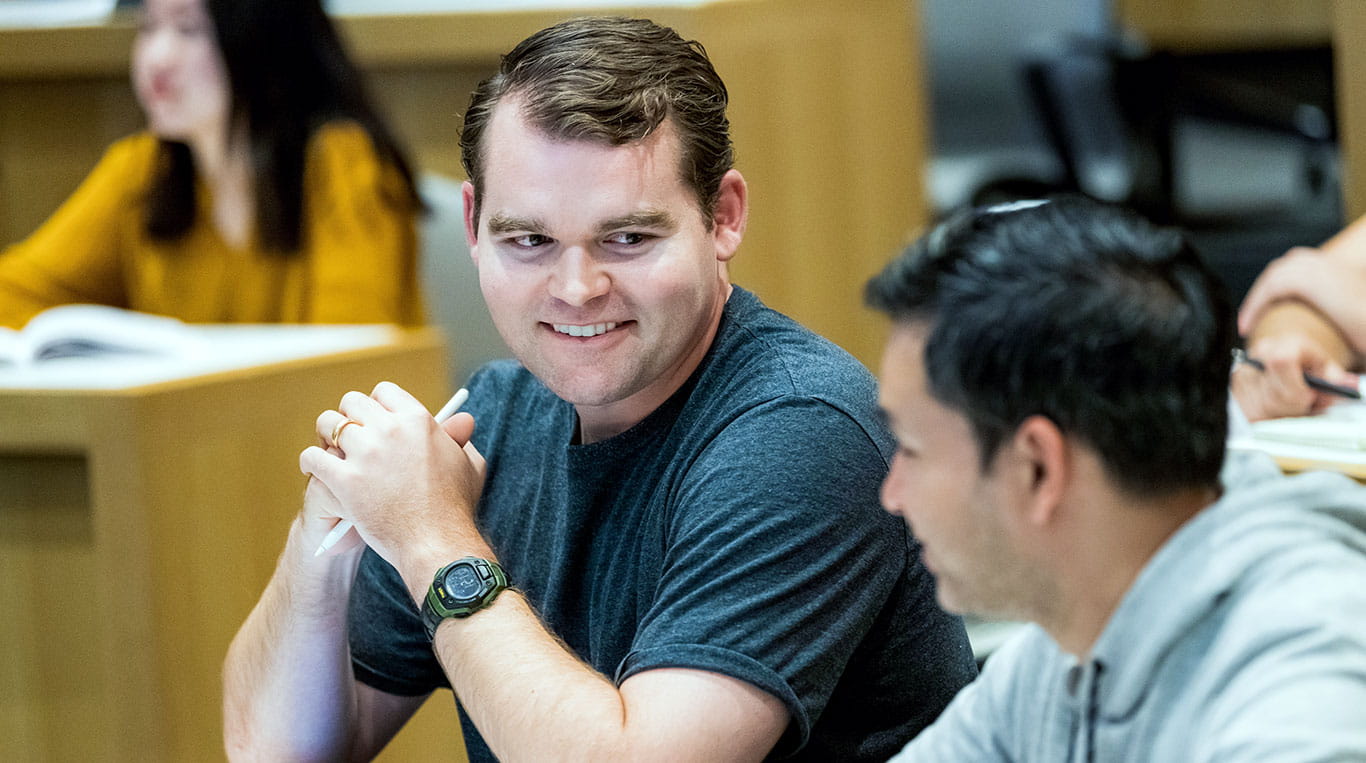 Kellogg MBA students talking in a lecture hall