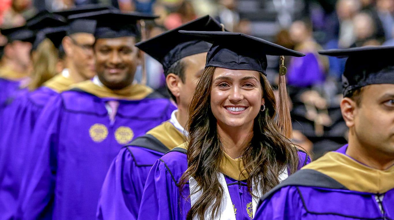 Kellogg MBA students in cap and gown at Convocation
