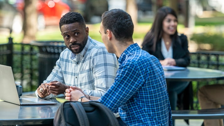Kellogg Evening and Weekend MBA students working at a laptop on the downtown Chicago campus
