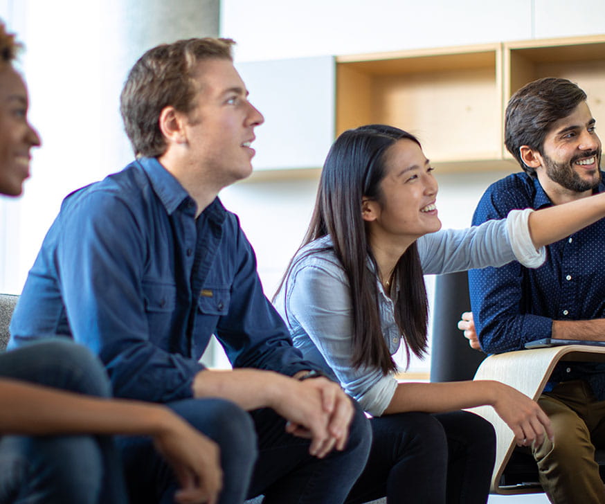 Four Kellogg students sitting together and talking.