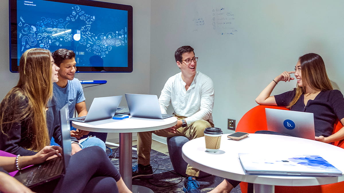 Students collaborating at a Global Hub meeting room