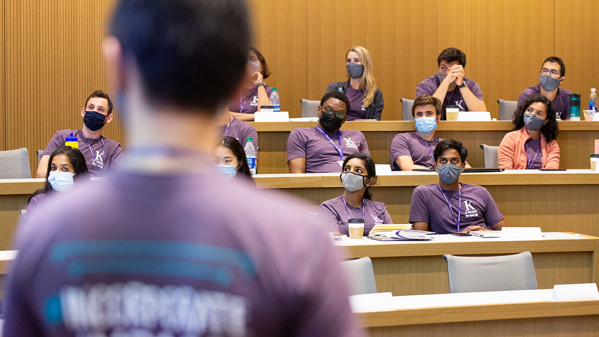 Group of students in a classroom participating in social impact programming at Kellogg