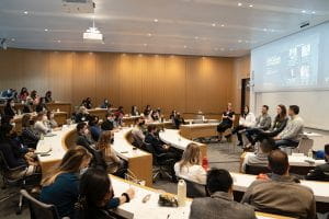 Classroom with students listening to a panel discussion