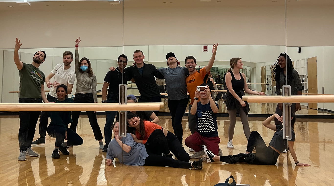 Students in a dance studio pose for a selfie while rehearsing for the Special K! annual musical production