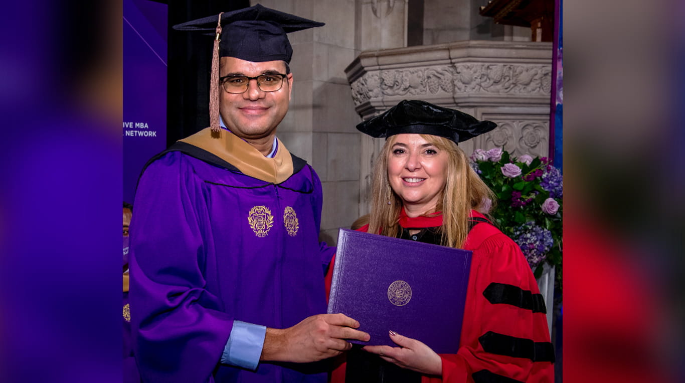 Kellogg graduate Ajay Kumar Gautam on graduation day with Dean Francesca Cornelli