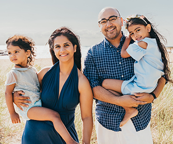 Kellogg graduate Ajit Kalra '20 with his wife, Sukhu, and their children