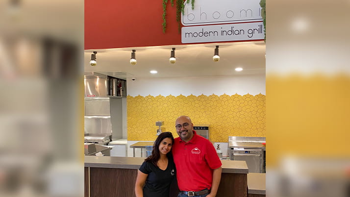 Restaurateurs Ajit and Sukhu Kalra stand outside their first location of Bhoomi Modern Indian Grill