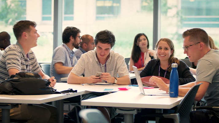 Kellogg students sitting around a table together having a conversation