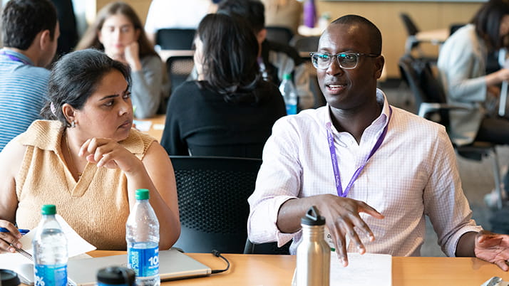 Two Kellogg students exchange thoughts during Social Impact Days at Kellogg