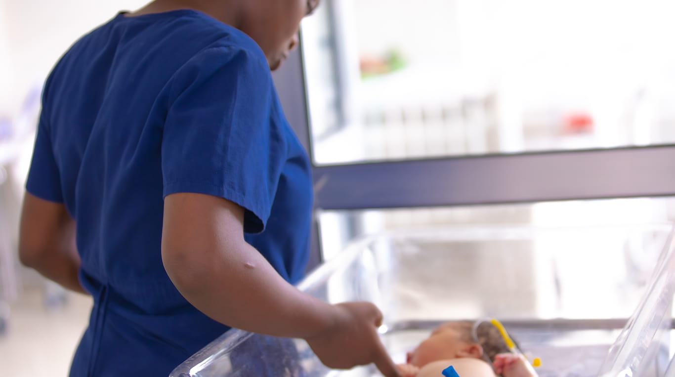 Doctor with newborn, the Nest 360 Project a global effort involving researchers from Kellogg and Northwestern