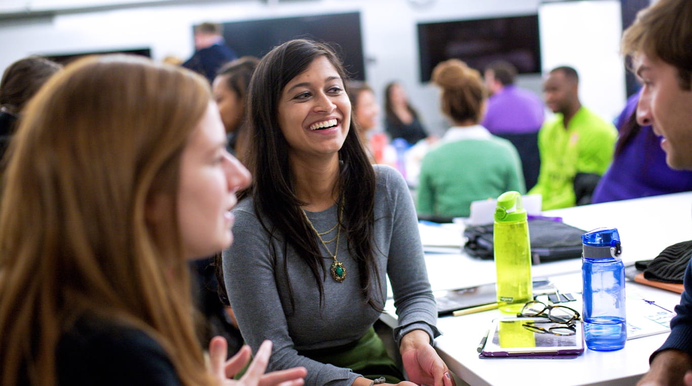 Group of people having a lively conversation around a table