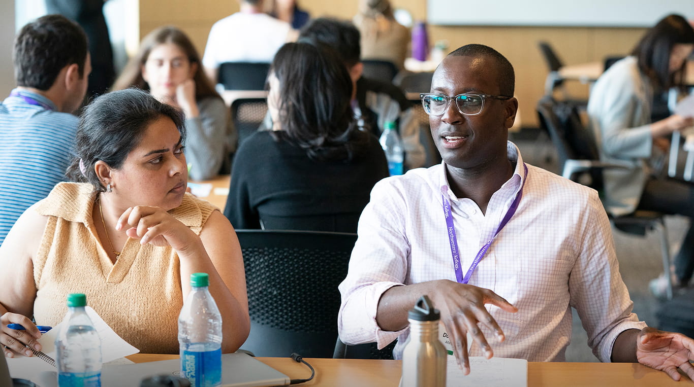 Two Kellogg students at the Global Hub, join them and become a Kellogg Leader — app is now open
