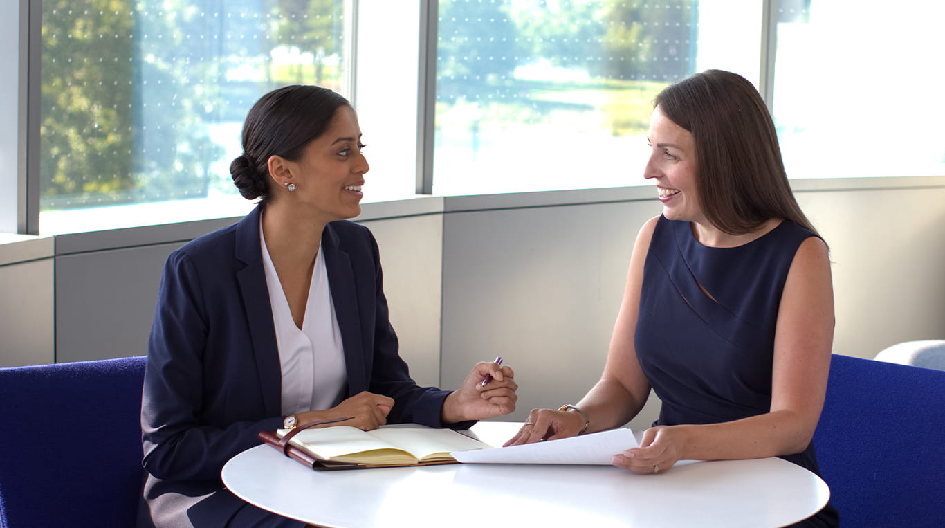 Two people discussing on how to frame your professional journey and choose the right letters of recommendation for your MBA application