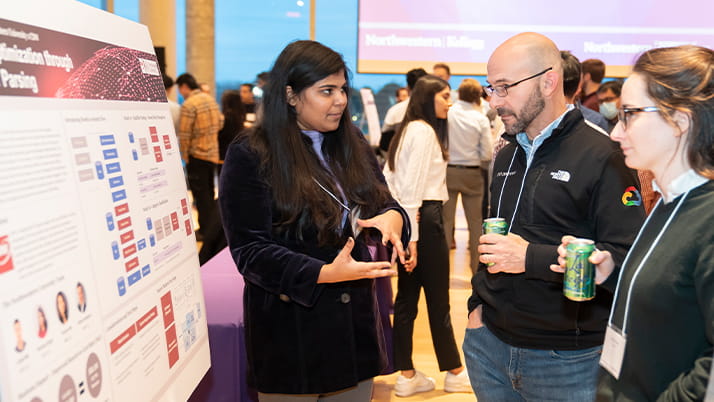 A student explains her project during the MBAi + MSAI Captone Showcase at Kellogg
