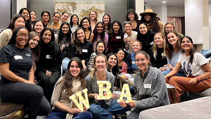 Group of women posing with "WBA" letters.