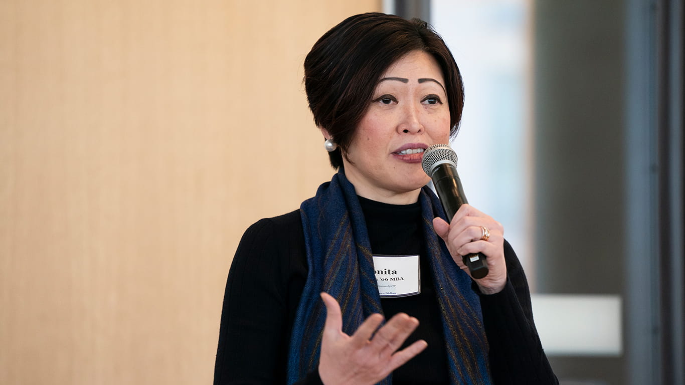 Alumna Sonita Lontoh holds a microphone while speaking at a Kellogg event on campus in spring 2024.