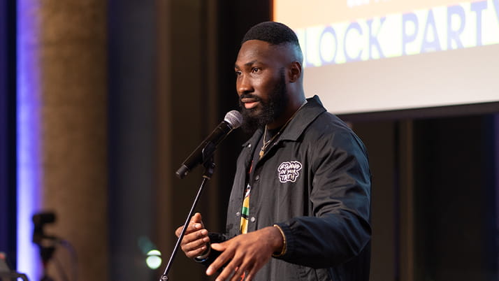 Osamase giving a poetry reading at Kellogg