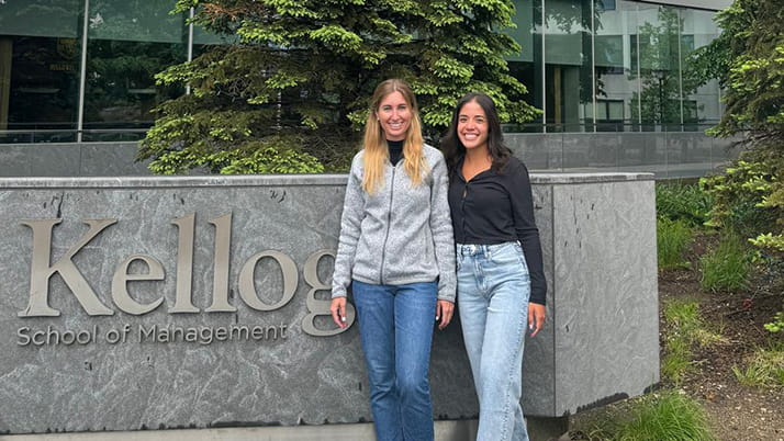 Two female MBA students who graduated in 2024 and who are members of the K-Latam standing in front of the Global Hub