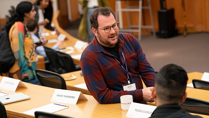 Youn Impact Scholars had opportunities to network throughout the two-day event. Here one scholar takes time to chat with his peer in between the day's programming. 