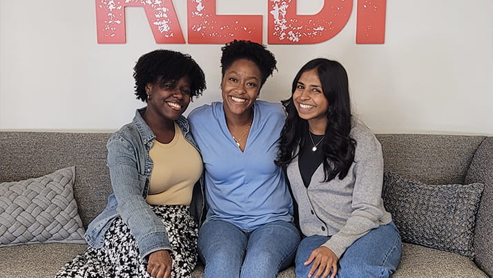 Nicole Rogers (center) with two of her colleagues at REDF