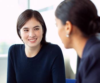 Two professional women discussing career strategies