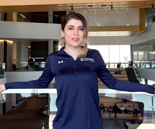 Zar Afsari ’25 Two-Year MBA Program leaning on a balcony at the Global Hub in Evanston.