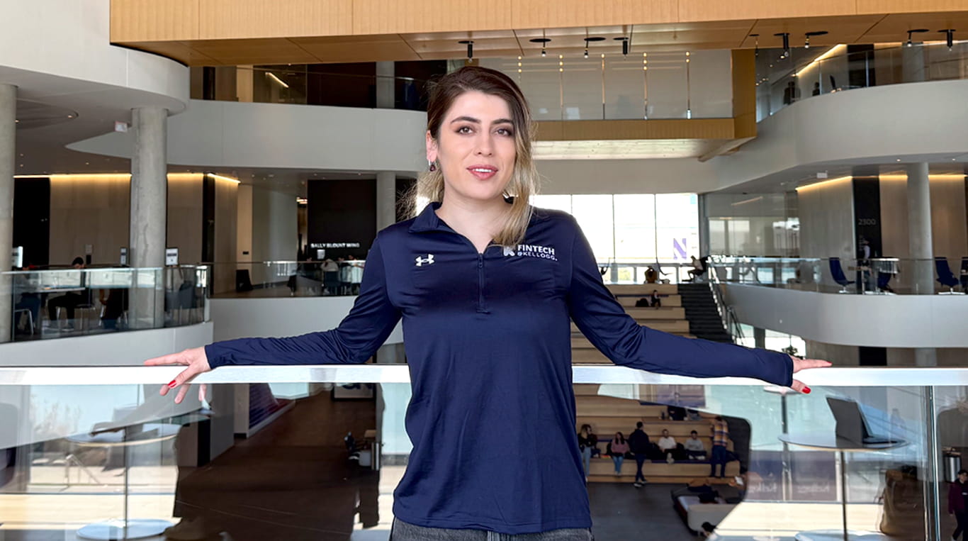 Zar Afsari ’25 Two-Year MBA Program standing against a balcony at the Global Hub