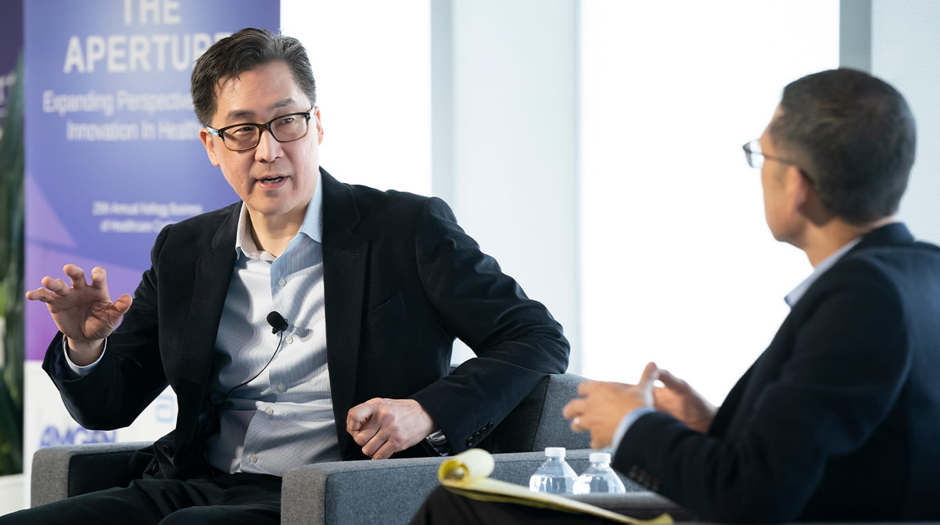 Two business leaders discussing healthcare innovation at a business conference at Kellogg.